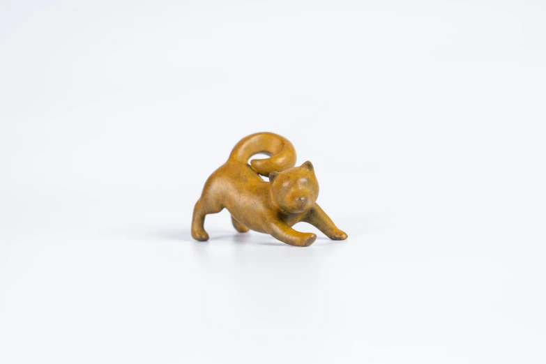 figurine of a cat is made from yellow colored clay