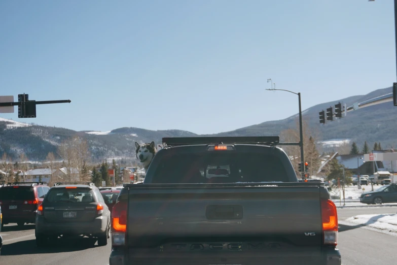 a truck stopped on a road near some mountains