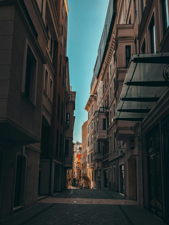 a street with several buildings lining the sides and one car parked in front