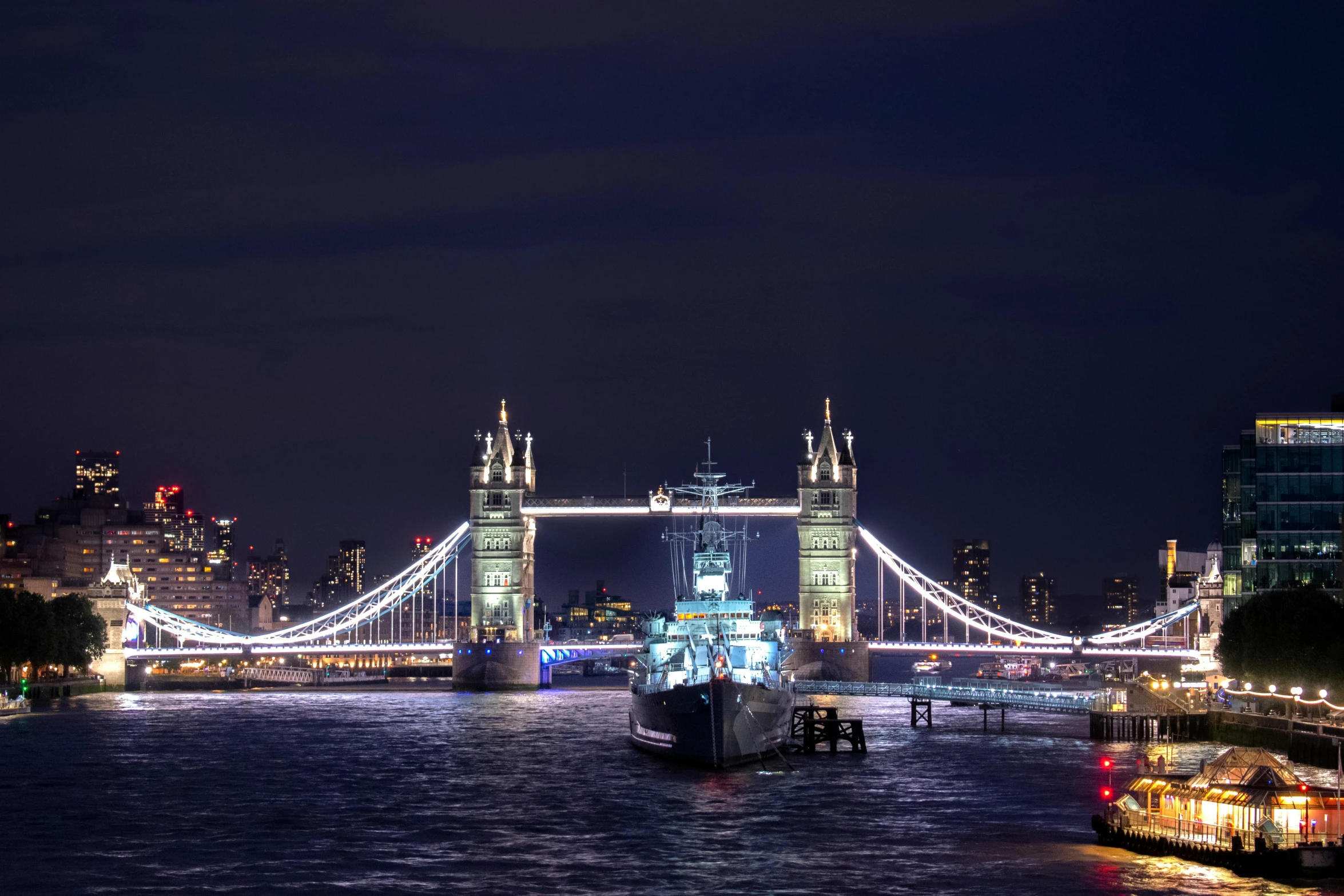 a large boat with some lights on in the water