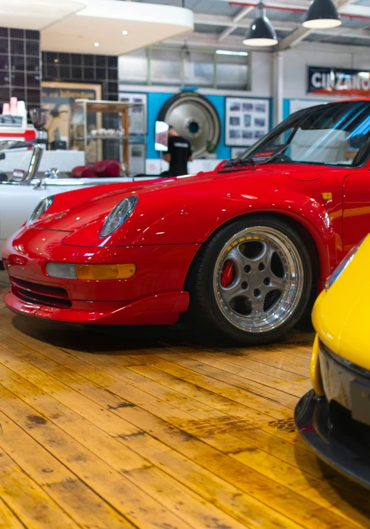 two bright colored cars parked in a room