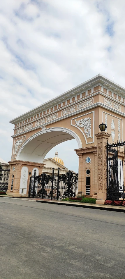 an ornate building is in front of a gate