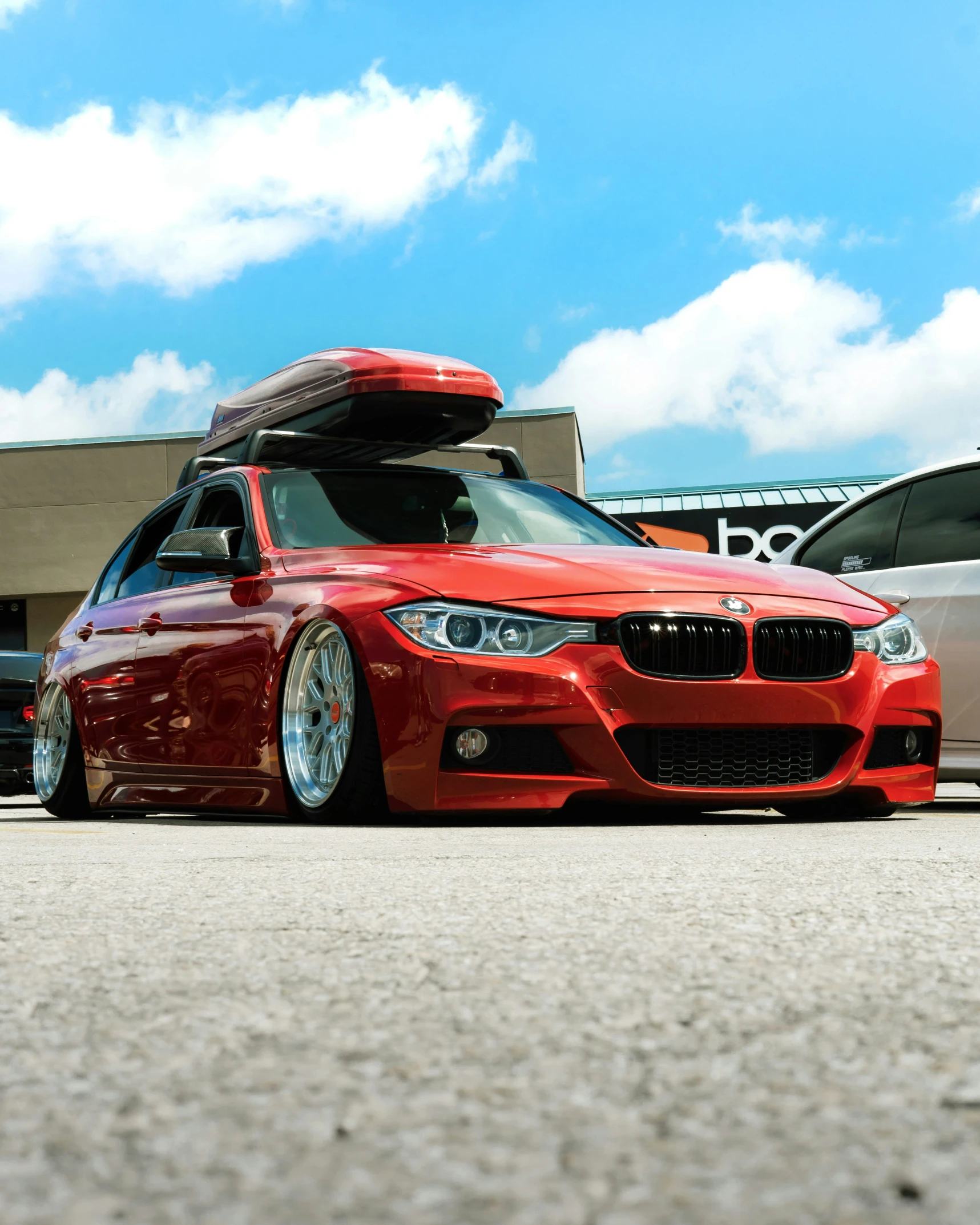 a red car with a surfboard strapped to it