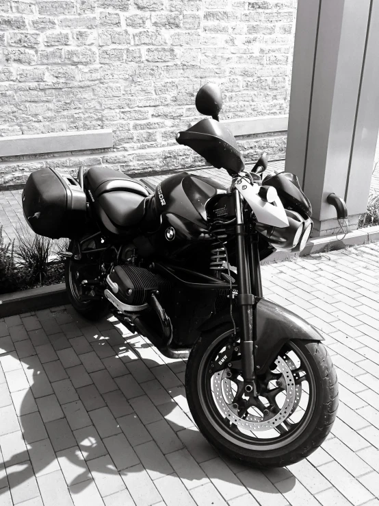 a parked motorcycle sitting next to a stone wall