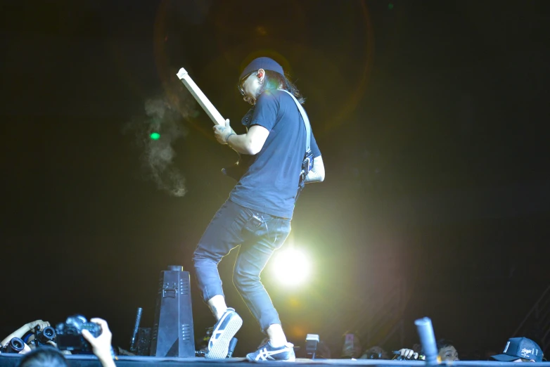 a man in the midst of playing on an electronic stage