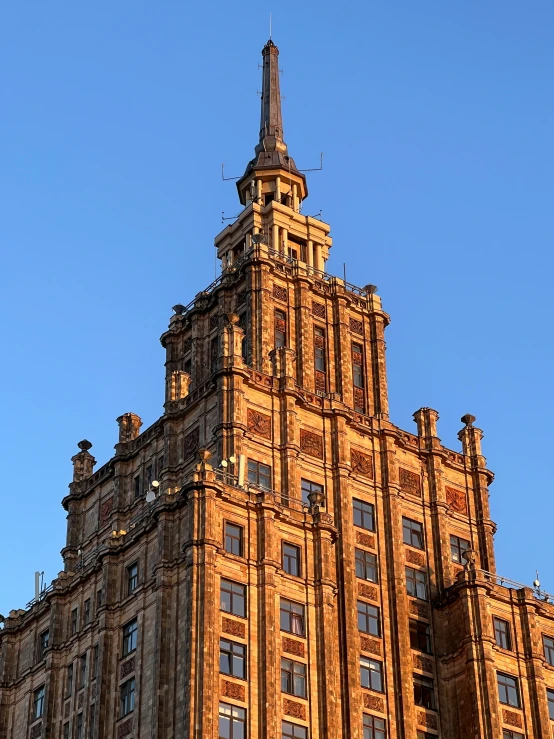 an old brick building with a weather vane on top of it