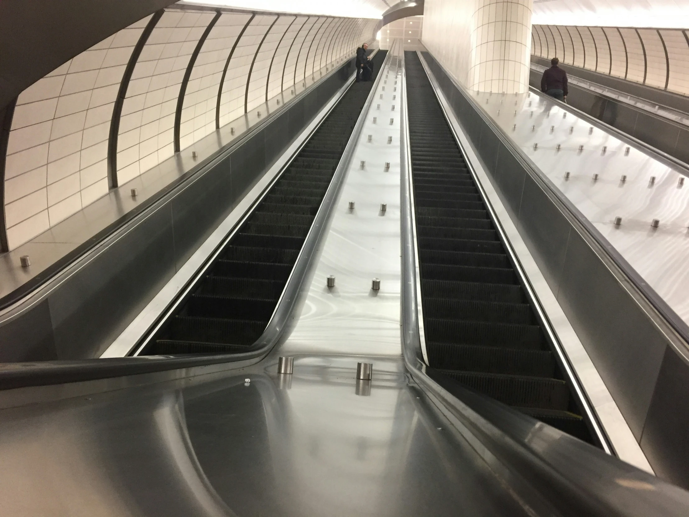 there are two escalators running along the empty walkway