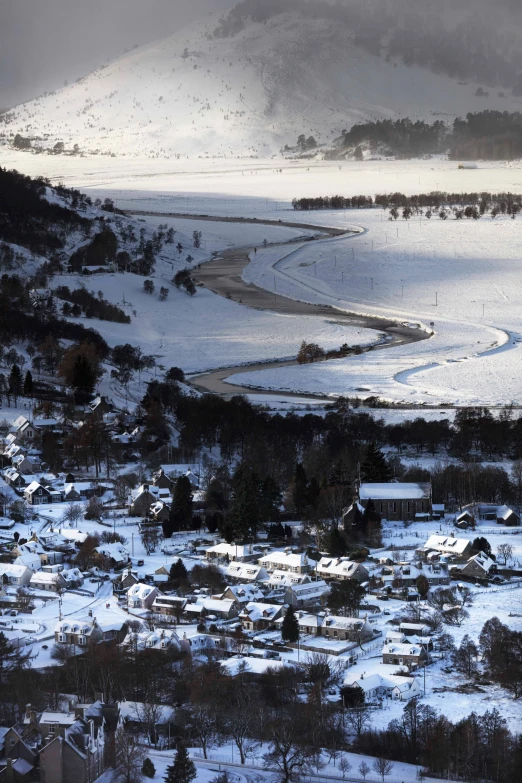 a view of a snowy town with houses