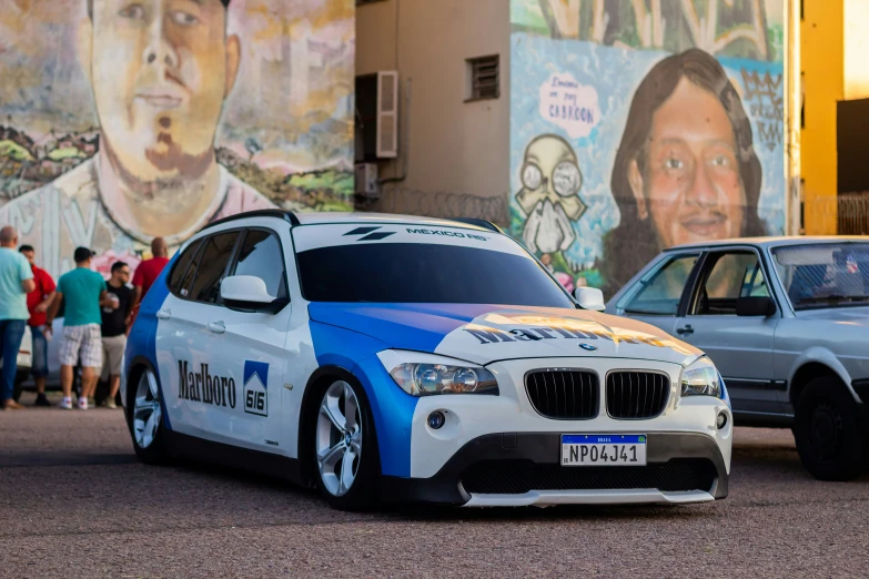 there are two bmw cars parked next to each other