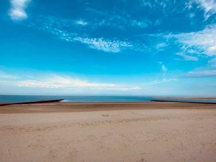 the lone surfboarder is seen at the beach