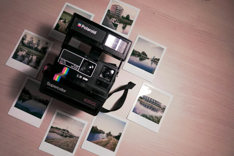 a polaroid camera is seen surrounded by old instaxe cards