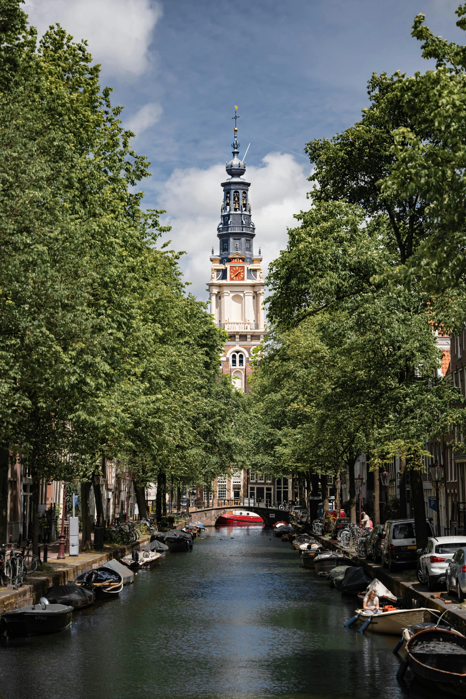 a narrow canal with boats parked on the side