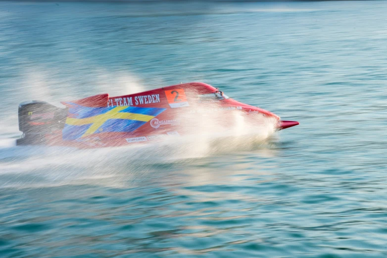 a water craft with a splash of spray and colorful paint on it