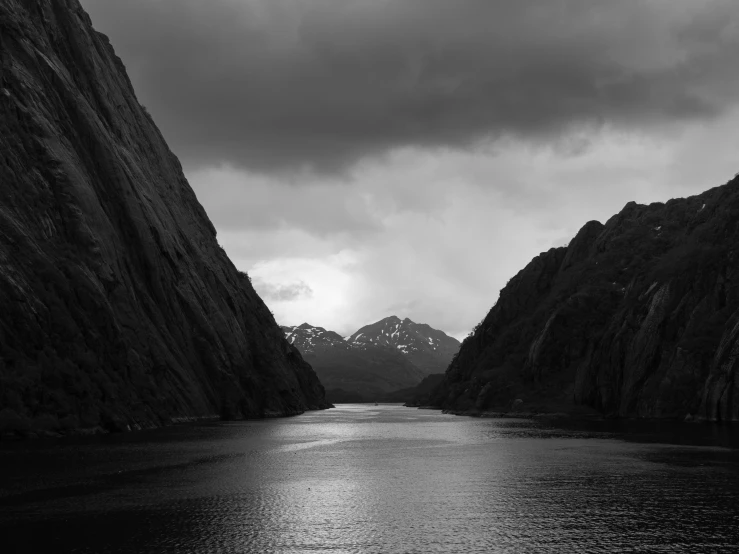 a body of water next to some mountains