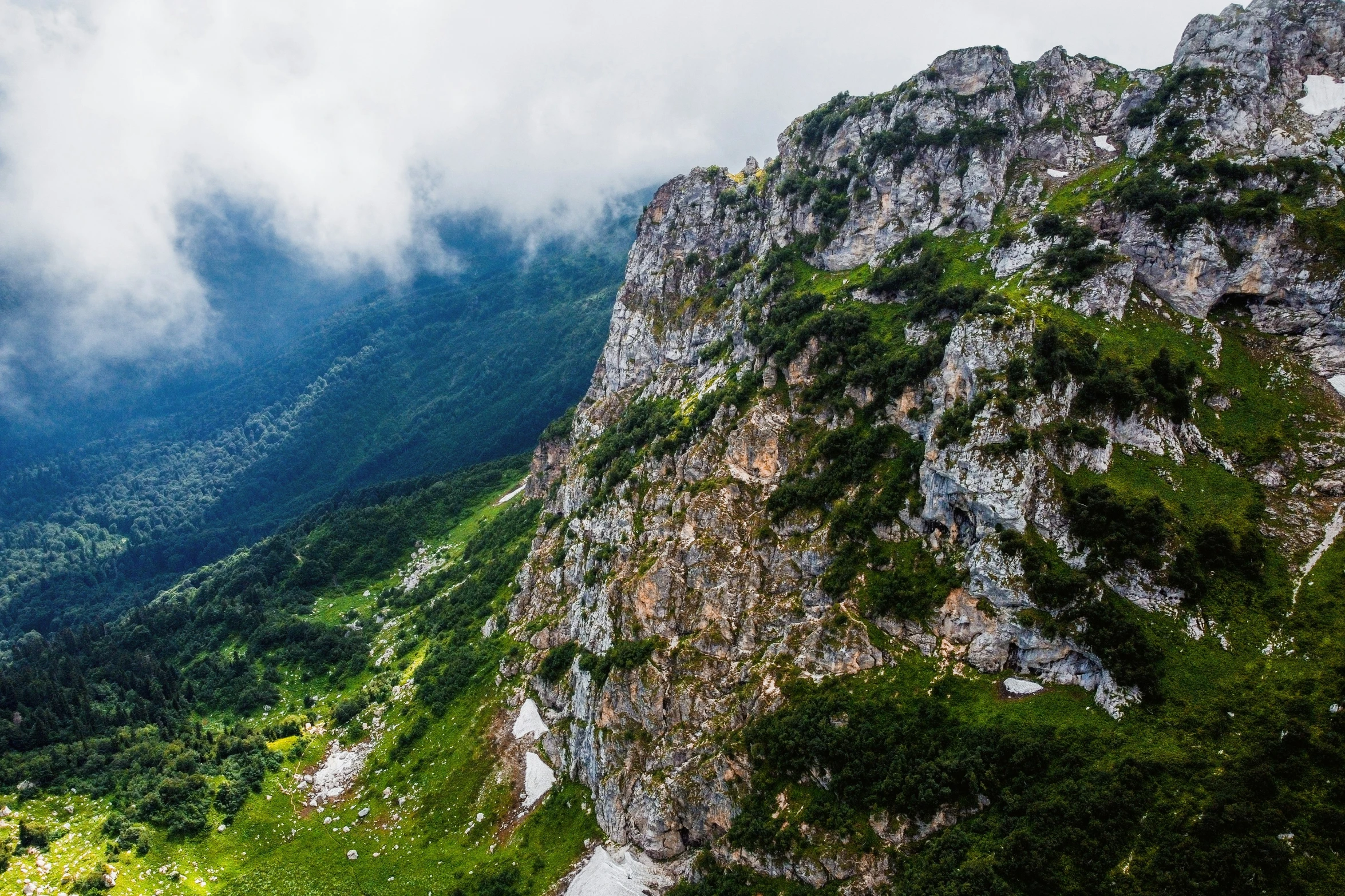 view from top of a mountain, clouds moving over the mountains