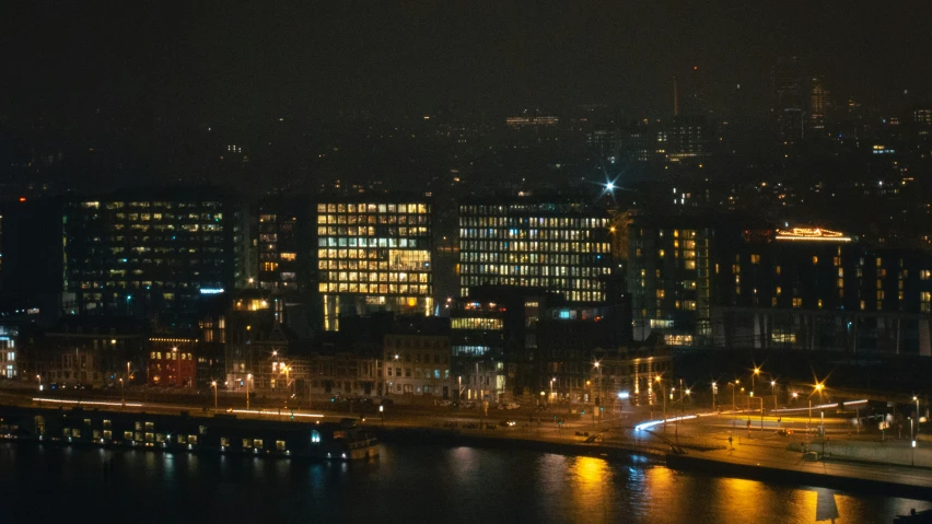 a nighttime po of the city lights reflecting in the water