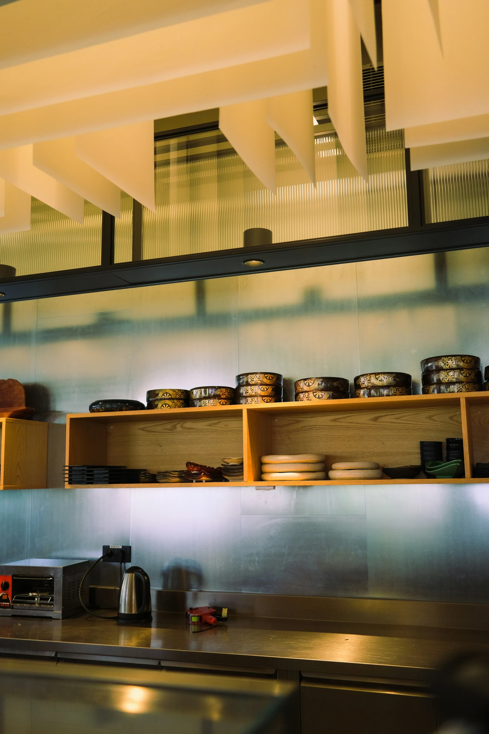 a kitchen with shelves with pots and pans