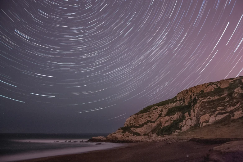 the night sky is lit up by the stars that streak across the night sky