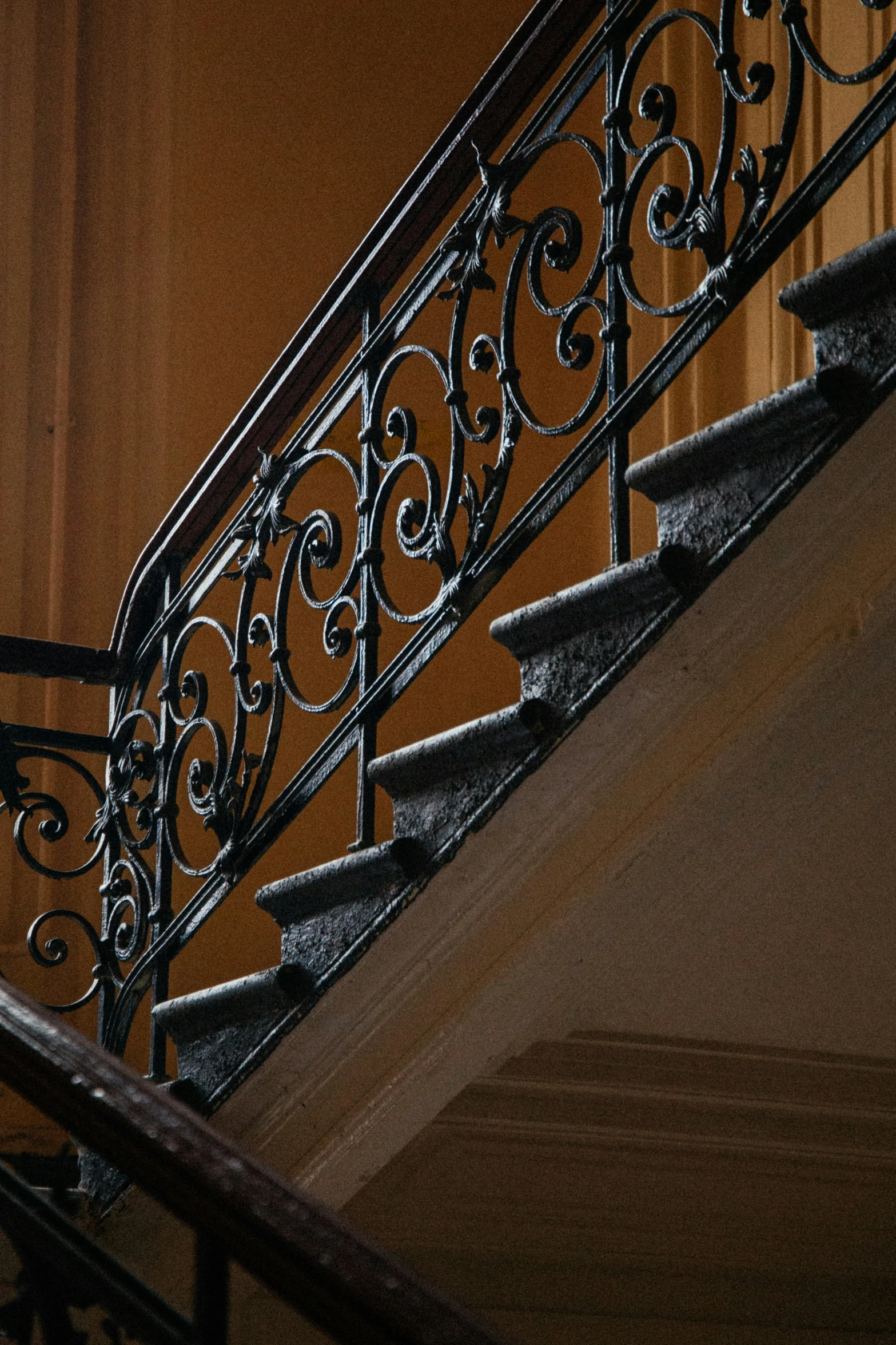 an iron stair railing and hand rail inside a house