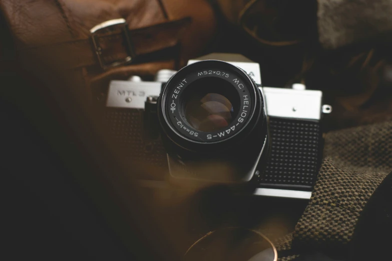 a small camera laying on top of a brown couch