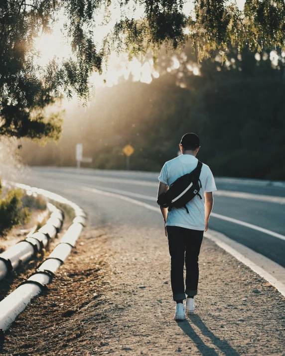 a man walking down a street with a back pack