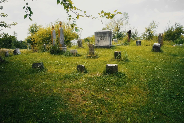 a grave yard with many old tombstones in the grass