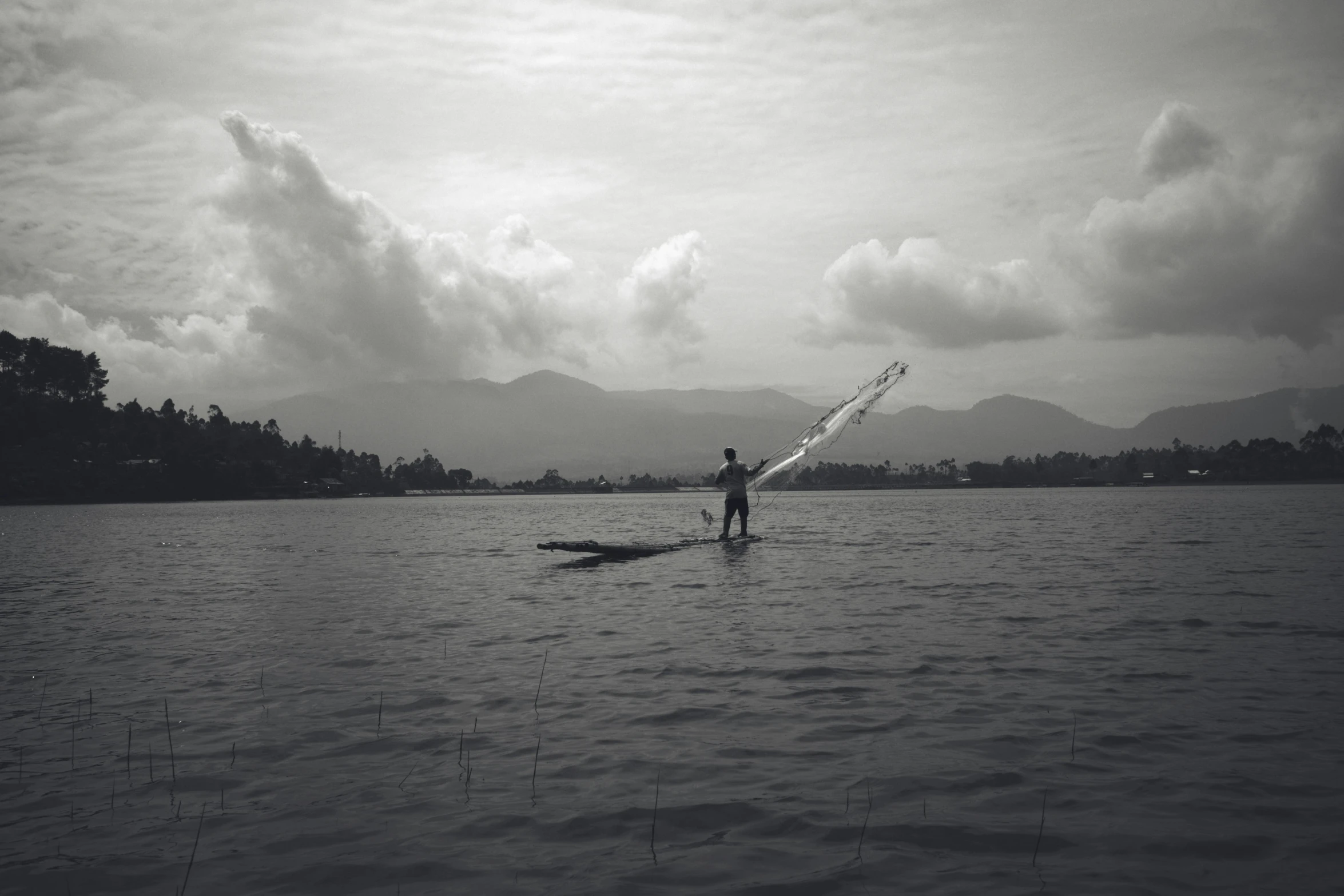 the person is standing on a surfboard in the water