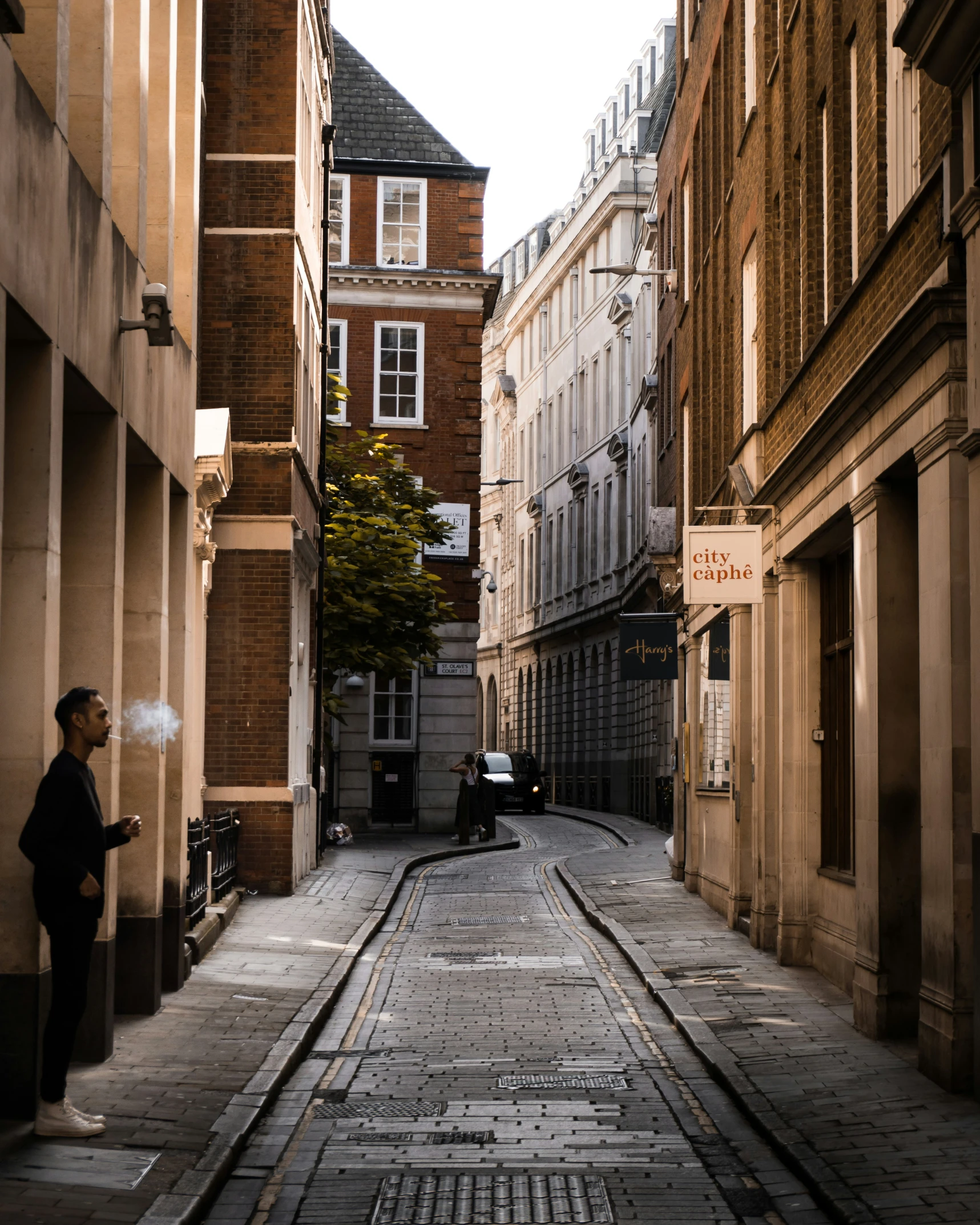 man is talking on his cell phone in the streets of town