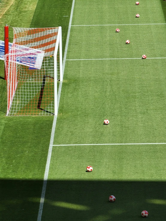 soccer field with lots of pink and red balls