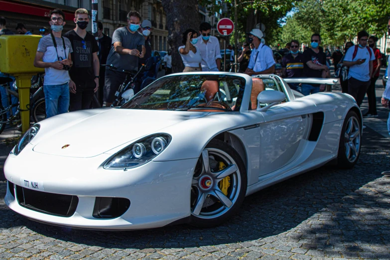 a woman sitting in a white sports car