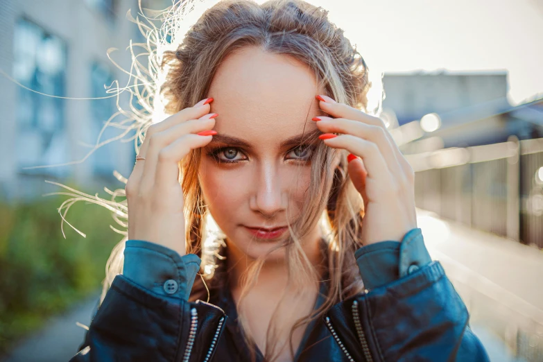 an attractive young woman poses for the camera