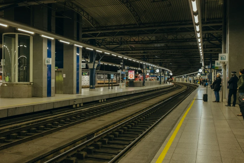 a subway station with people waiting for the train