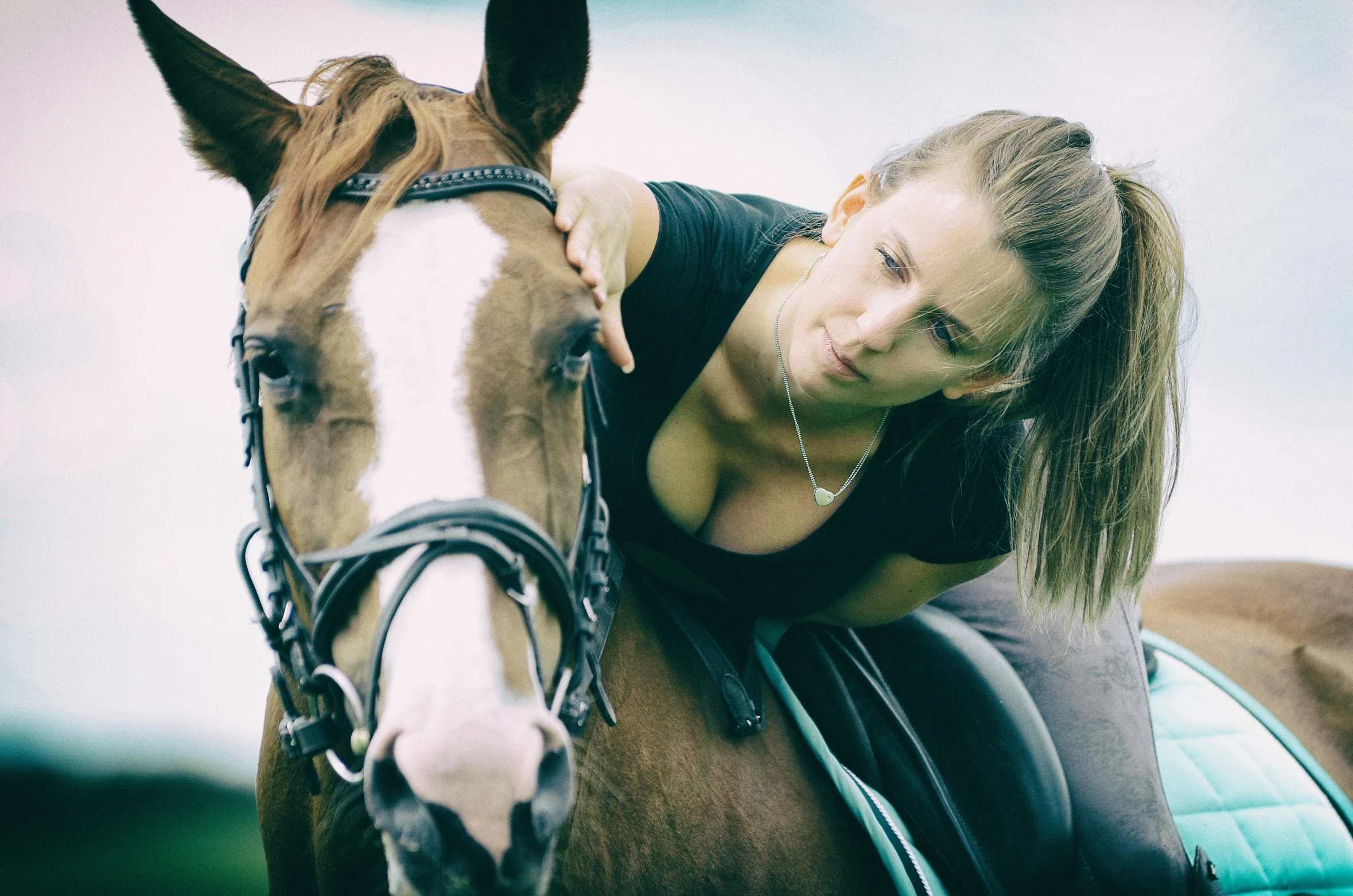 the young lady is posing with her horse