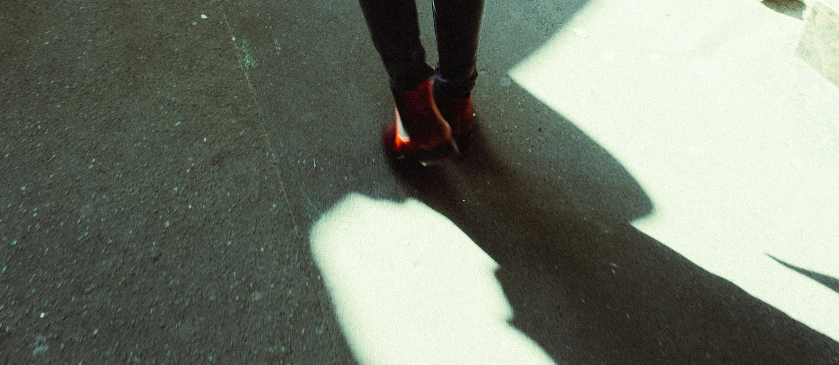 a woman riding a skate board on a street