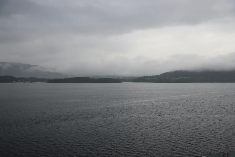 a large body of water under a cloudy sky