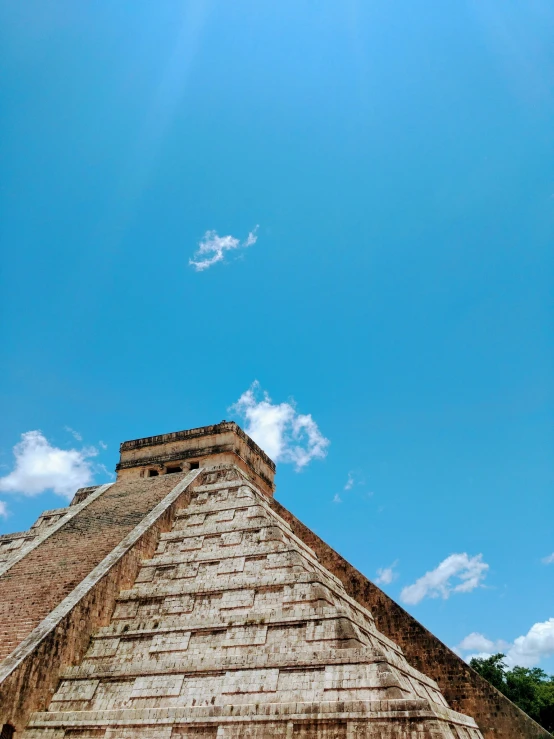 a large brick pyramid sitting on top of a wooden platform