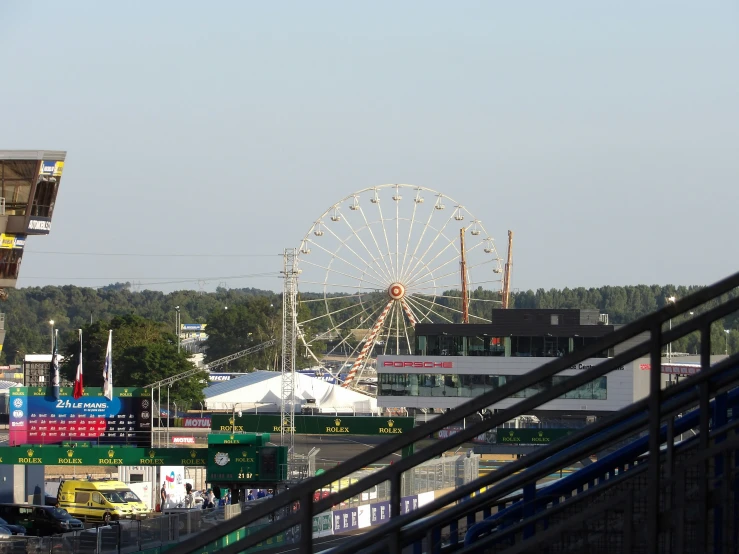 a ferris wheel surrounded by buildings and trees