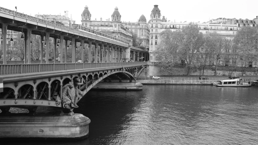 a view of a bridge over a body of water near buildings