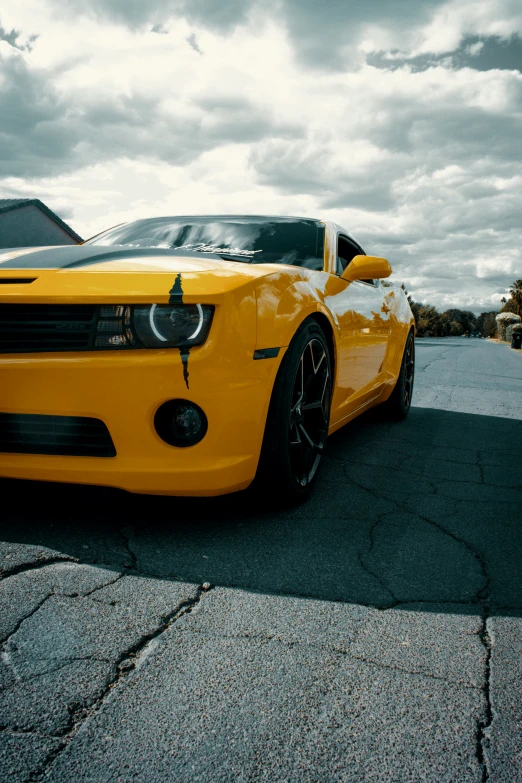 a sporty yellow sports car parked on a parking lot