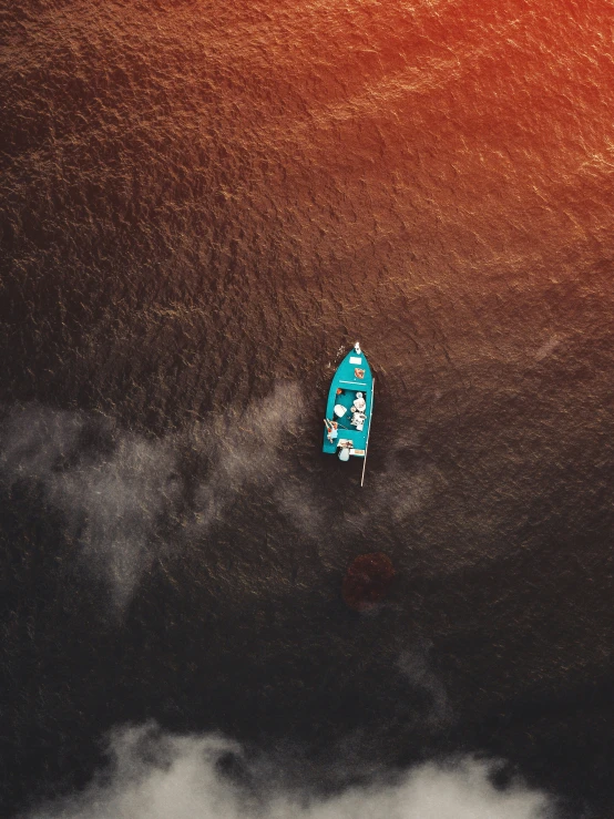 the sky has clouds and an overhead picture of a blue boat on it