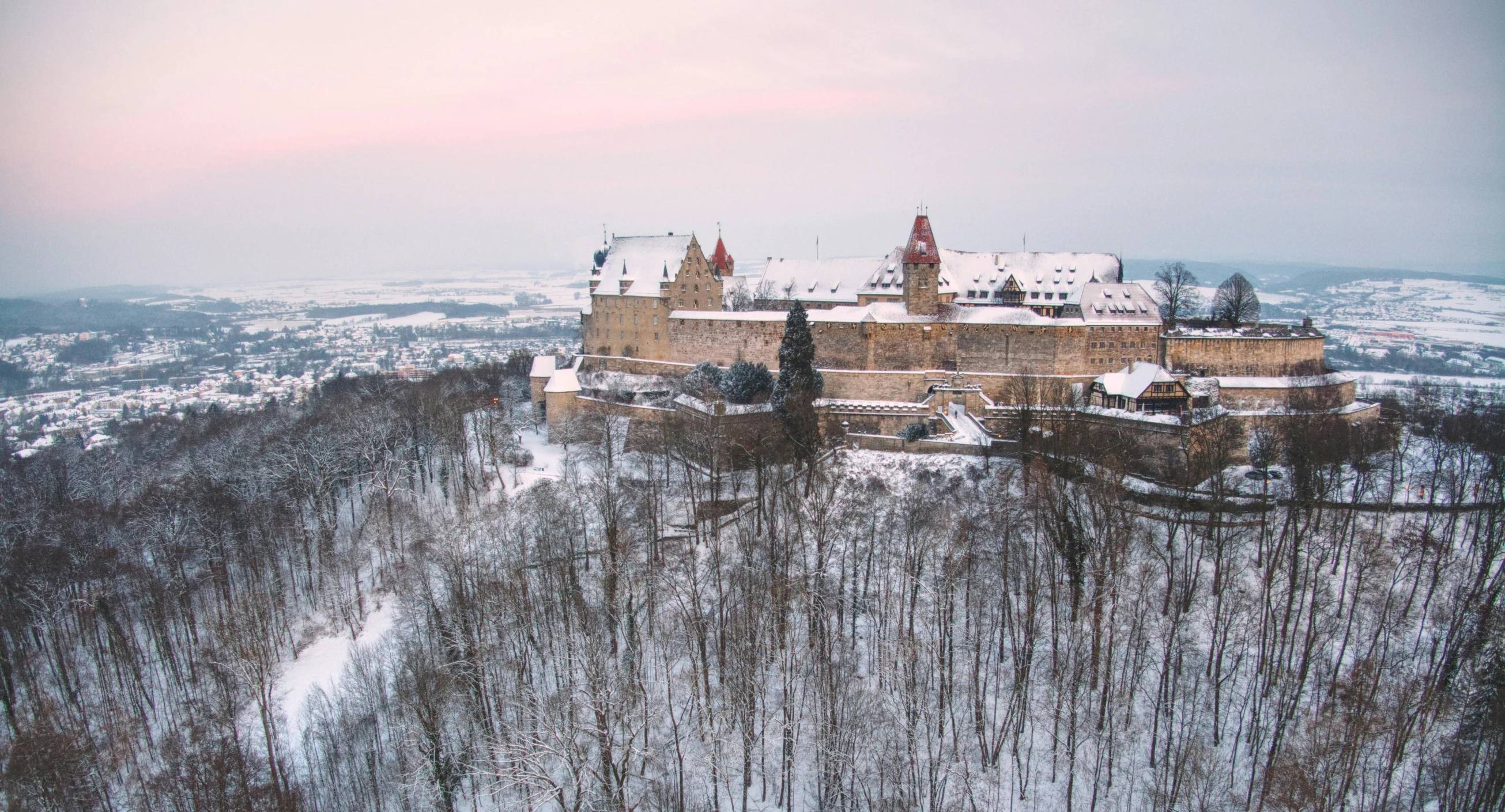 a large castle on top of a snowy hill