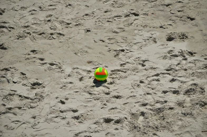 a beach ball that has been left on the sand