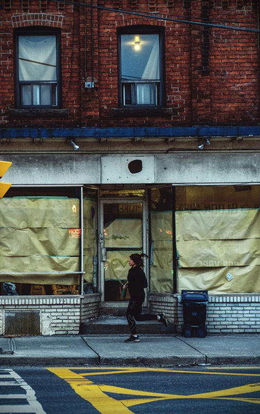 the outside of a store with a woman walking by