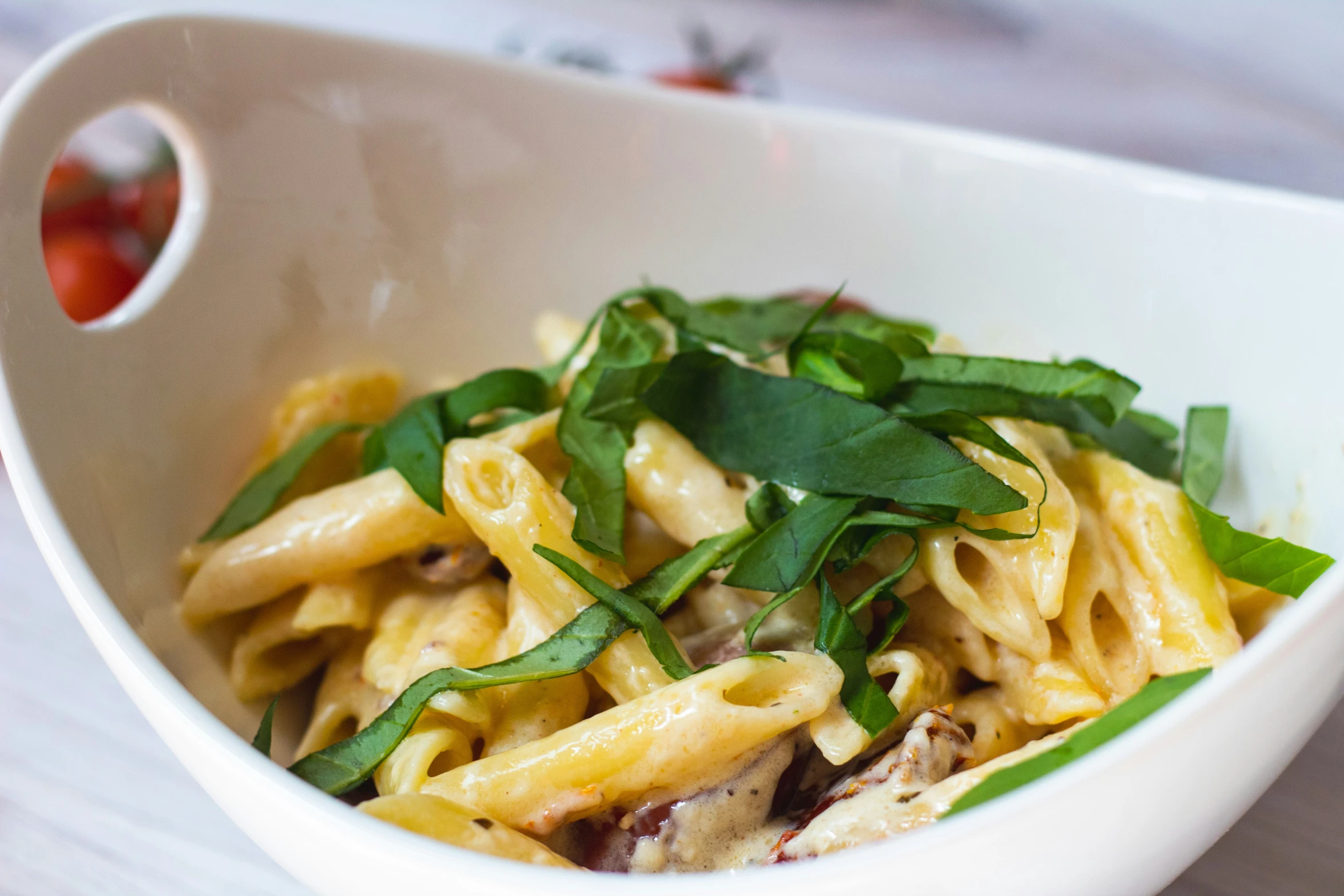 pasta with vegetables and herbs served in a bowl