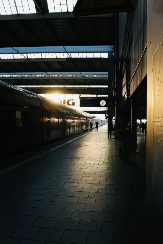 a long train at the station that is in the dark