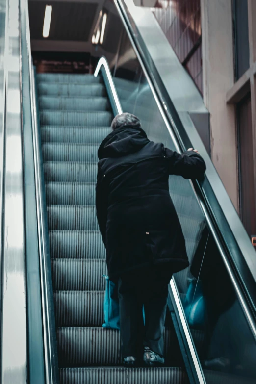 an image of a man riding up an escalator