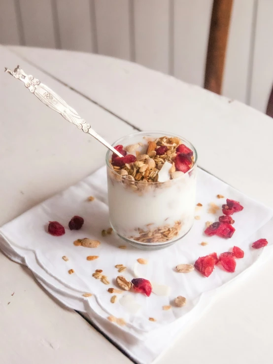 a glass with some fruit and cereal in it