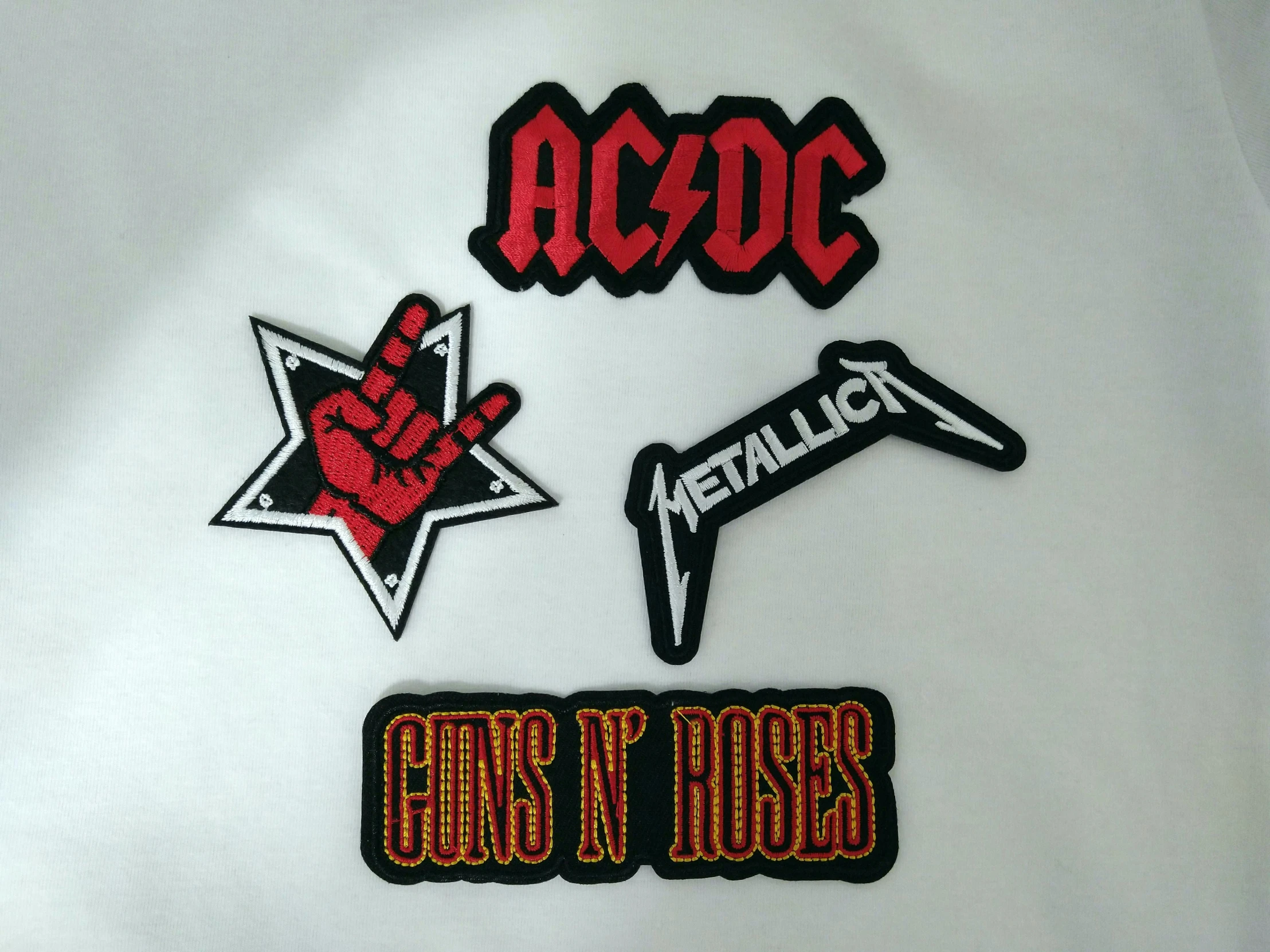 a set of three embroidered patches depicting various logos