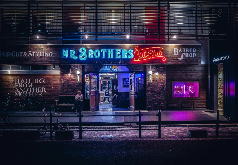 a neon sign advertising some restaurant's front doors