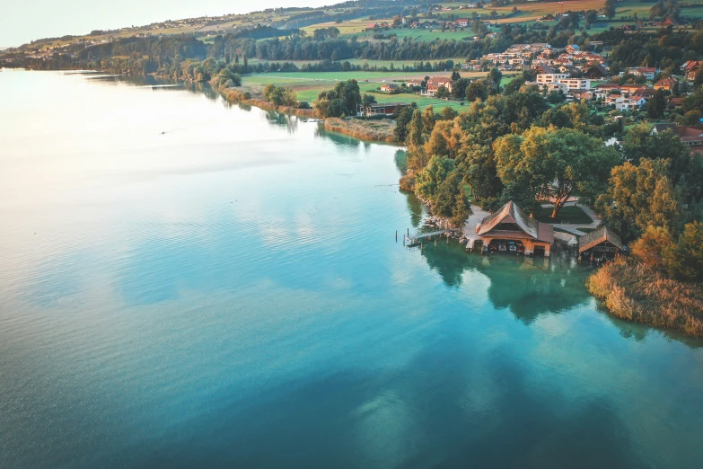 an aerial view of a lake and town in the distance